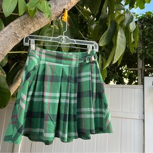 Urban Outfitters Pleaded Marianne Buckle Plaid Mini Skirt in Green.